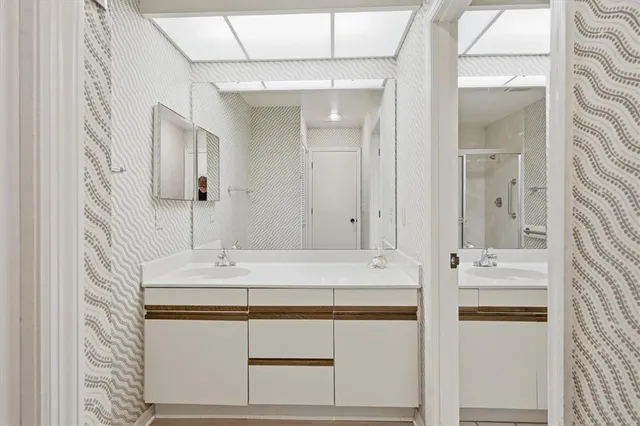 a spacious bedroom with a bed and a chandelier