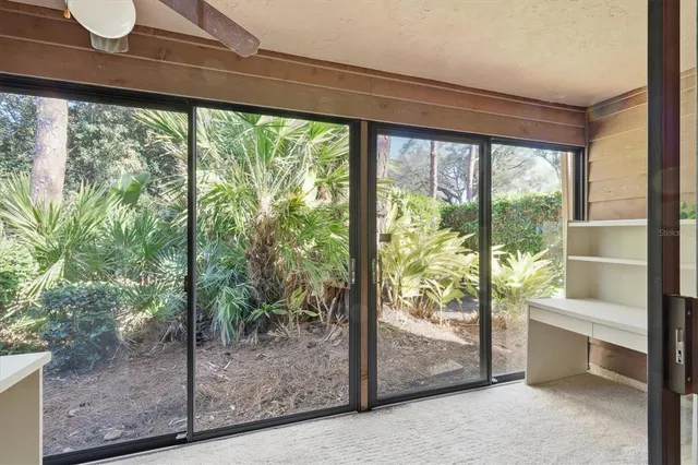 a view of a room with window and a ceiling fan