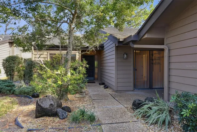 a backyard of a house with lake view and a potted plant