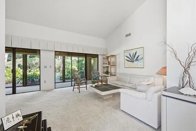 a living room with furniture and large windows