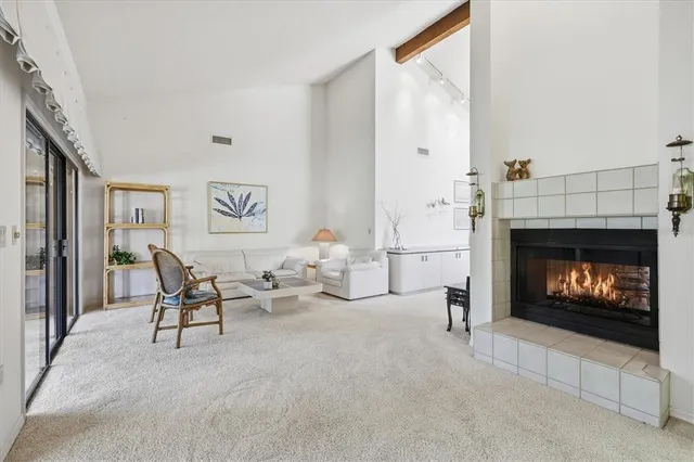 a view of an empty room with large windows