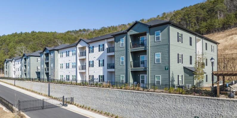 75 Overlook Parkway Southeast, Unit 324 Cartersville, GA 30121 - Photo 12 of 21 a view of a white building among the street with palm trees