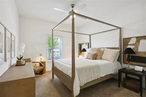 a bedroom with a bed and large mirror