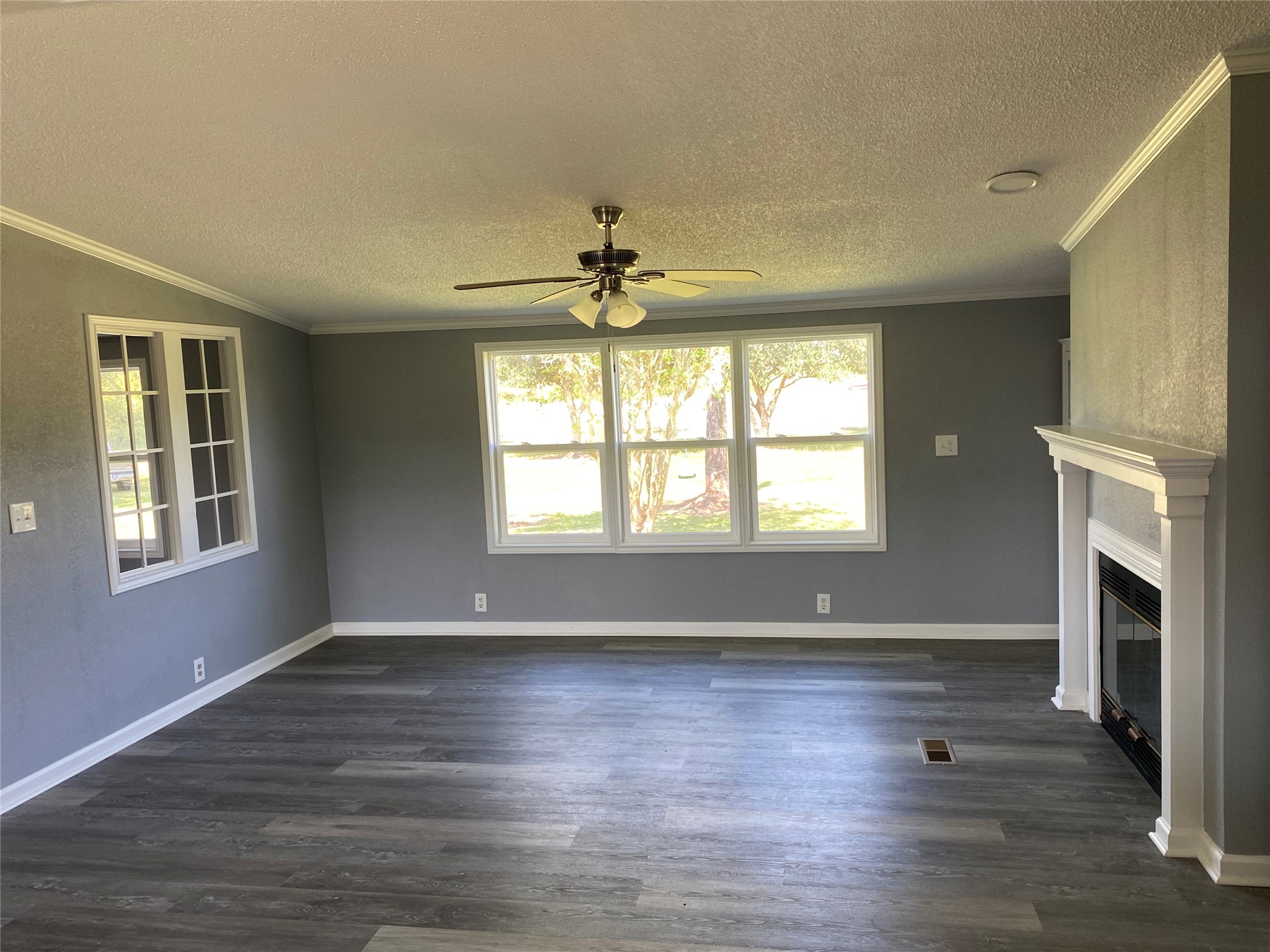 6115 Highway 35 Alvin, TX 77511 - Photo 22 of 49 an empty room with wooden floor fireplace and windows