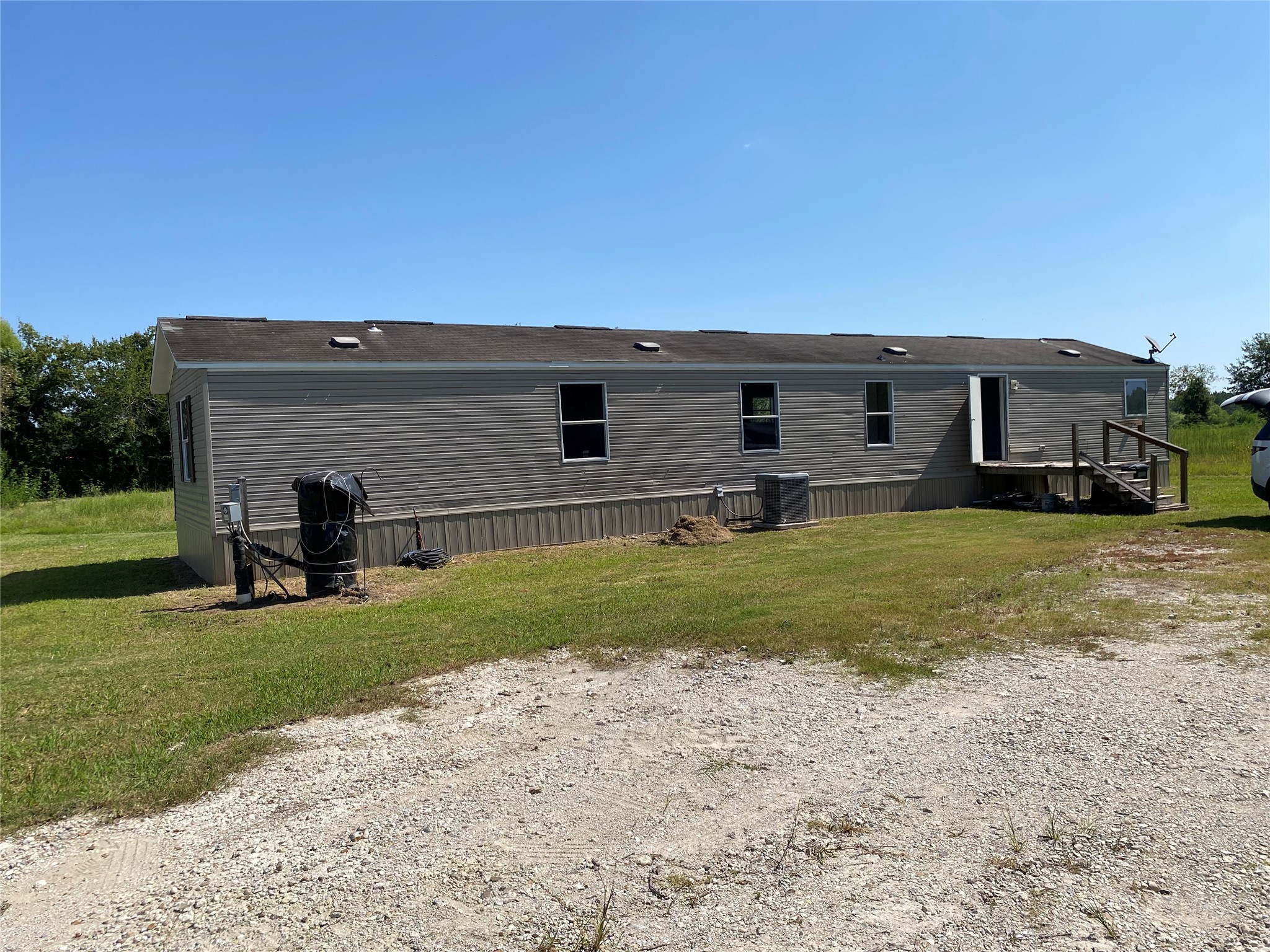 6115 Highway 35 Alvin, TX 77511 - Photo 31 of 49 a view of a house with a backyard
