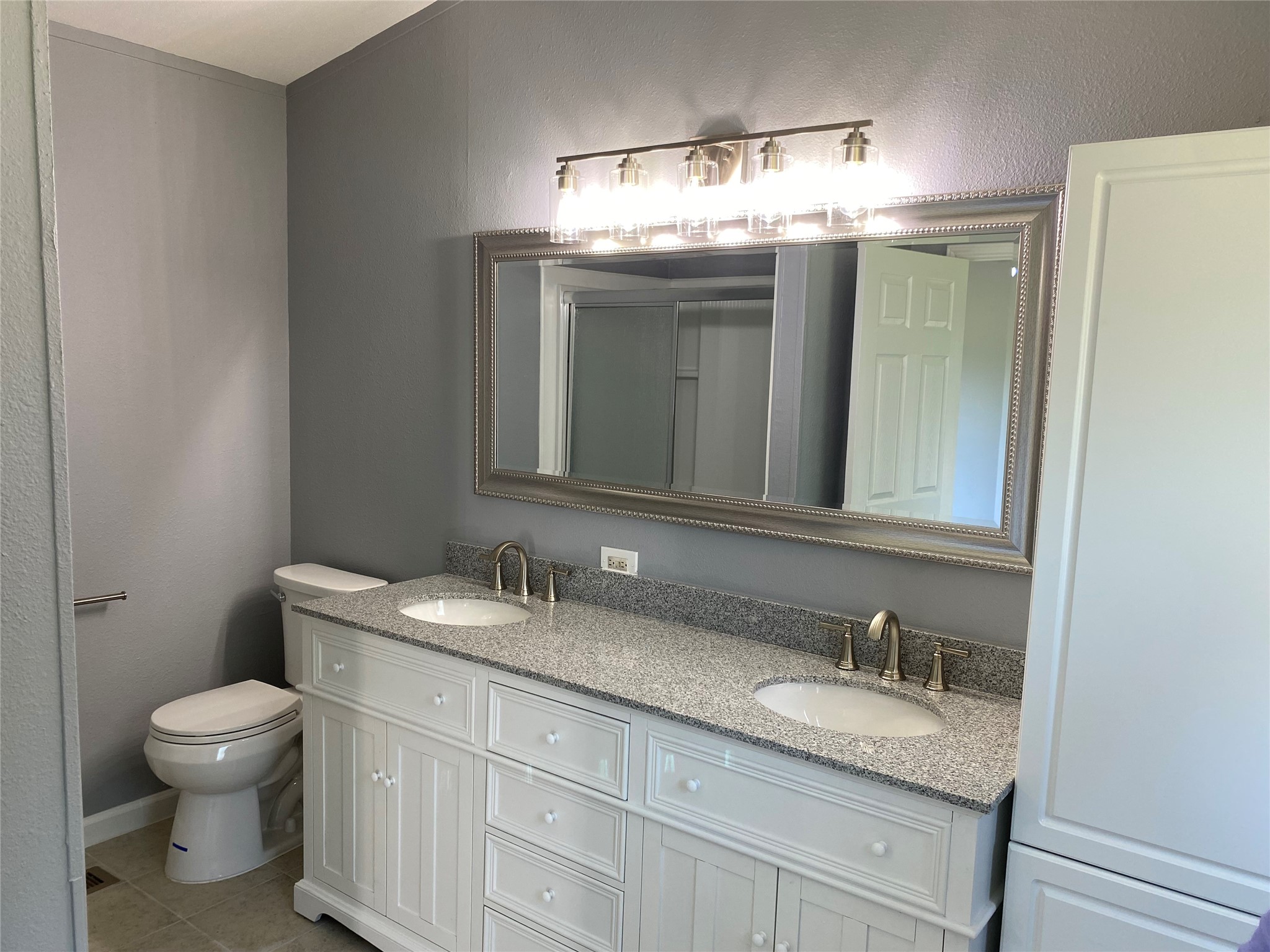 6115 Highway 35 Alvin, TX 77511 - Photo 35 of 49 a bathroom with a granite countertop sink a toilet and mirror