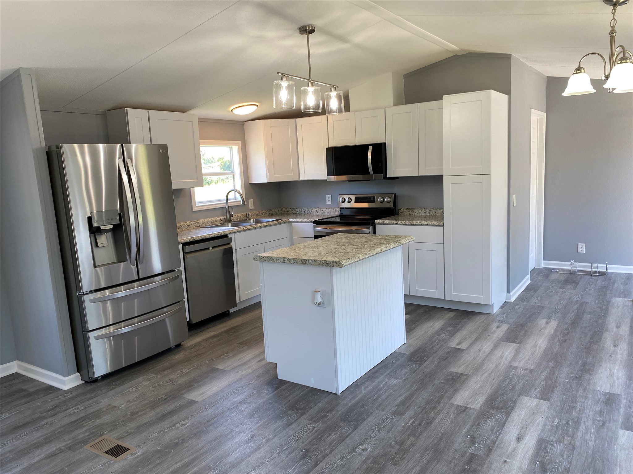 6115 Highway 35 Alvin, TX 77511 - Photo 38 of 49 a kitchen with stainless steel appliances a refrigerator stove a sink and white cabinets