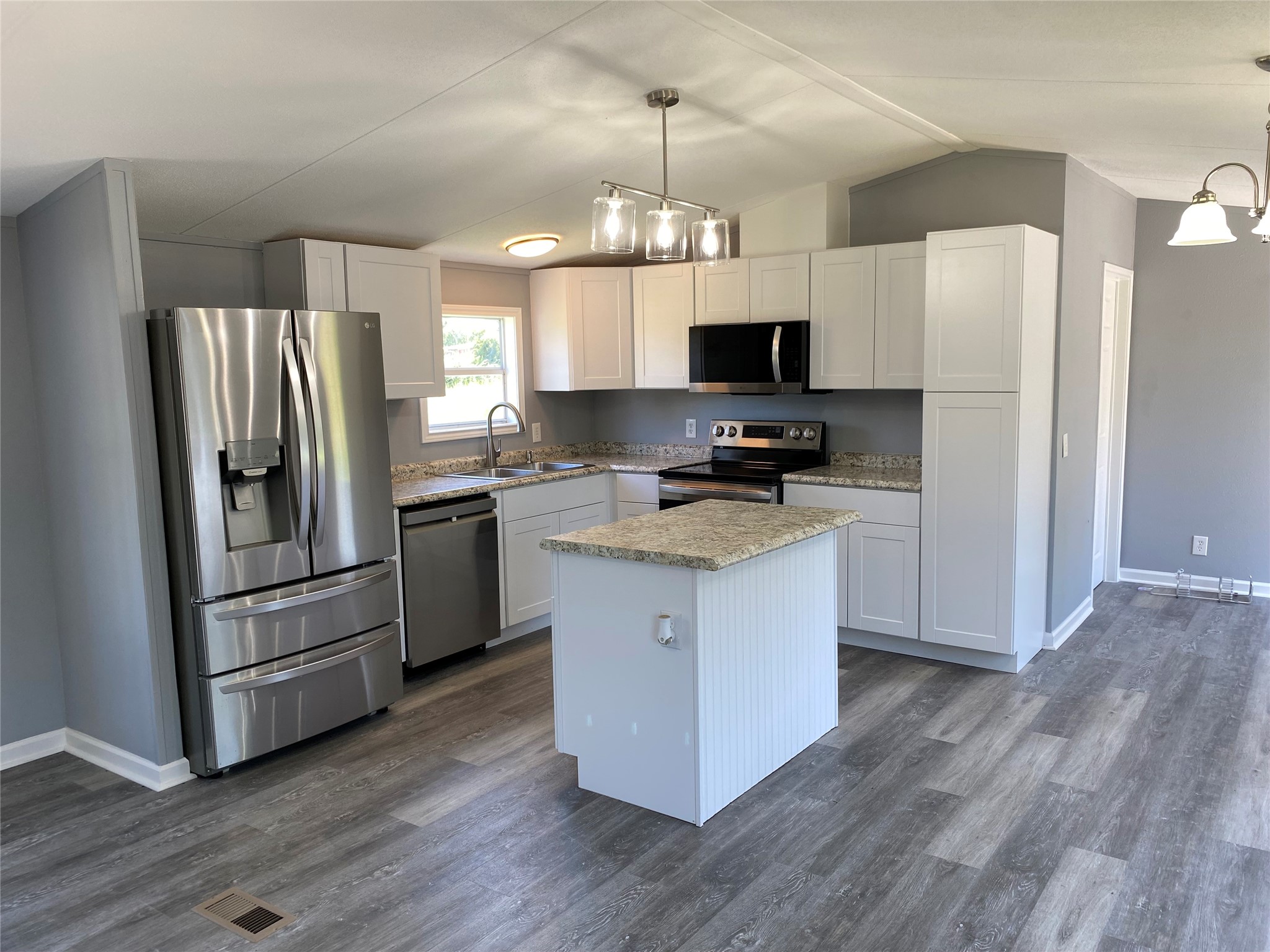 6115 Highway 35 Alvin, TX 77511 - Photo 39 of 49 a kitchen with a refrigerator stove and wooden floor