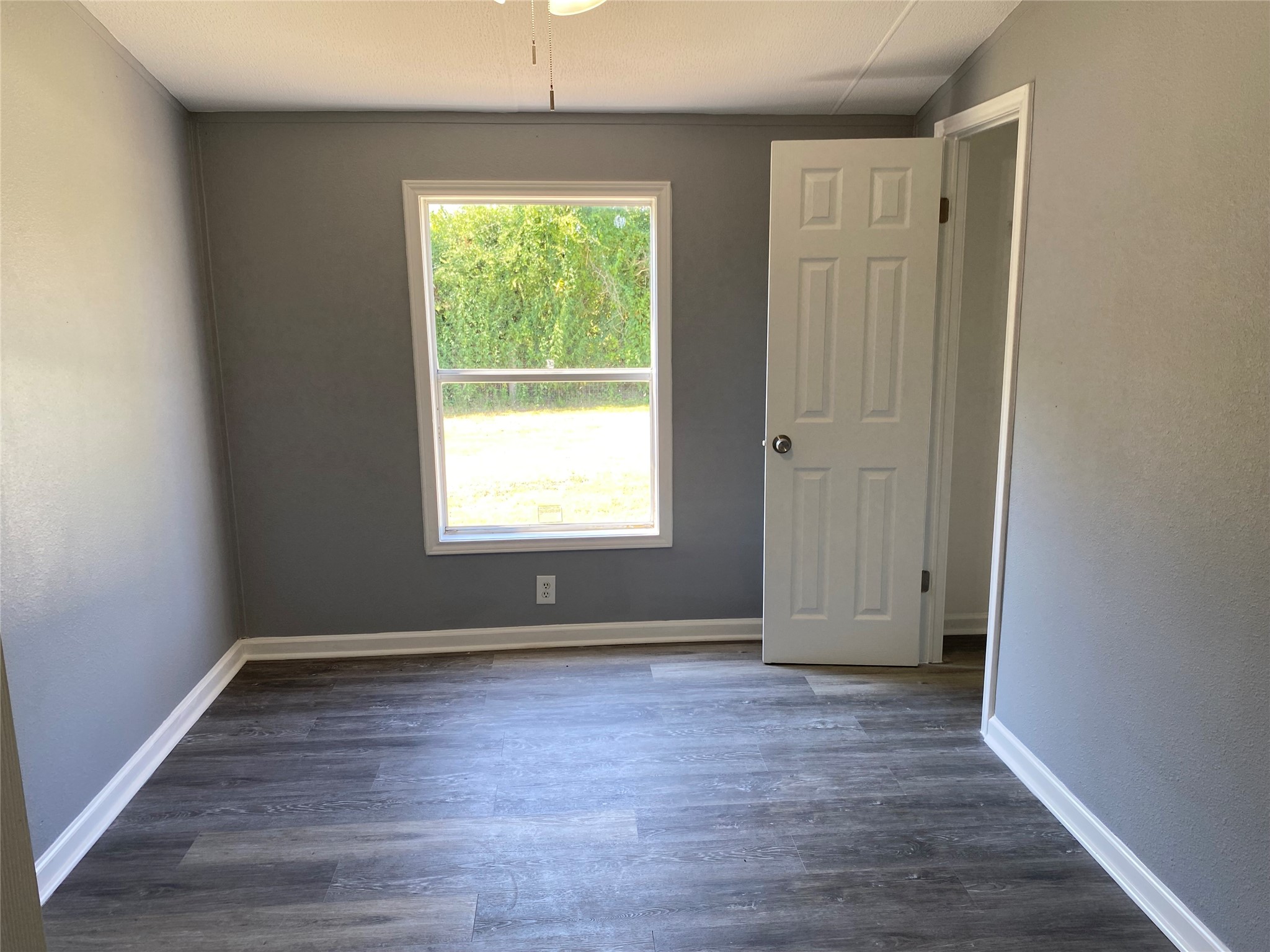 6115 Highway 35 Alvin, TX 77511 - Photo 43 of 49 an empty room with wooden floor and windows
