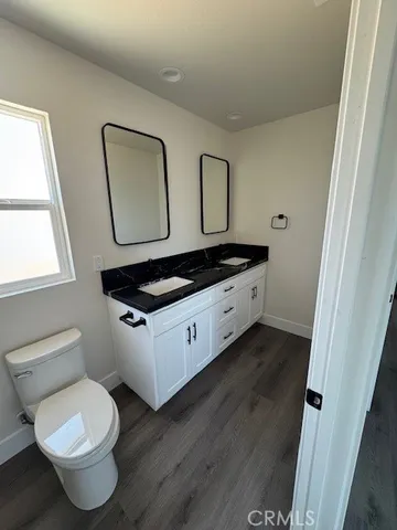 a spacious bathroom with a toilet sink and mirror