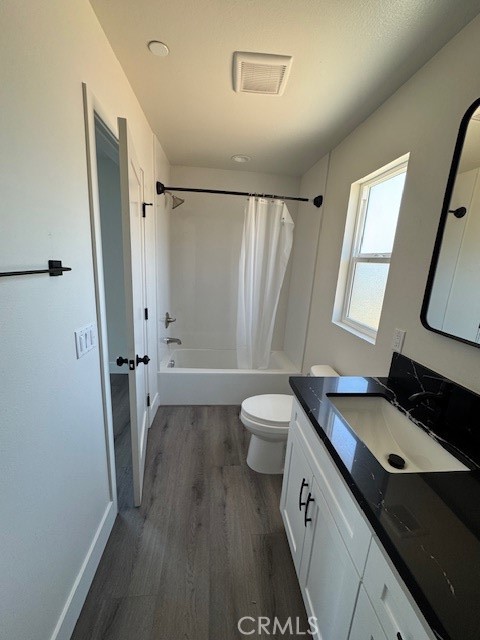 510 Ellis Lake, Unit 1 Lake Elsinore, CA 92530 - Photo 12 of 25 a bathroom with a granite countertop sink toilet a large mirror a vanity and a shower