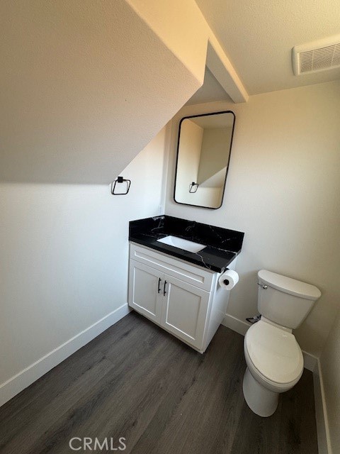 510 Ellis Lake, Unit 1 Lake Elsinore, CA 92530 - Photo 14 of 25 a bathroom with a toilet a sink and mirror