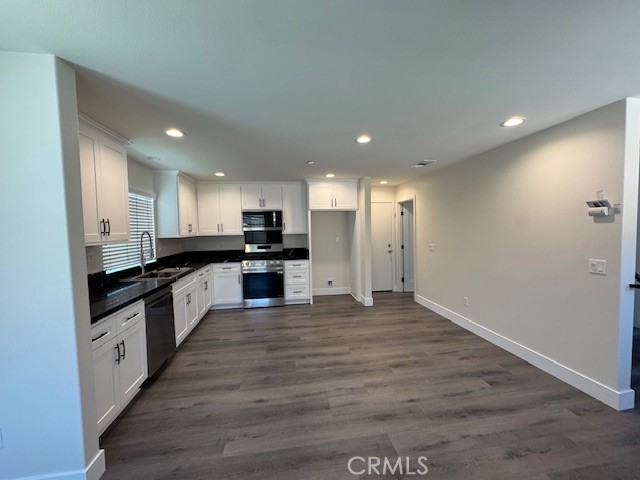 510 Ellis Lake, Unit 1 Lake Elsinore, CA 92530 - Photo 19 of 25 a large kitchen with stainless steel appliances granite countertop a large counter top and a stove top oven