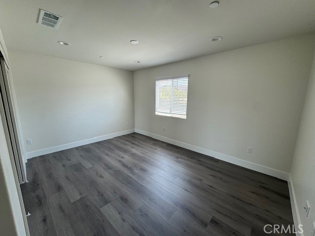 510 Ellis Lake, Unit 1 Lake Elsinore, CA 92530 - Photo 2 of 25 an empty room with wooden floor and windows