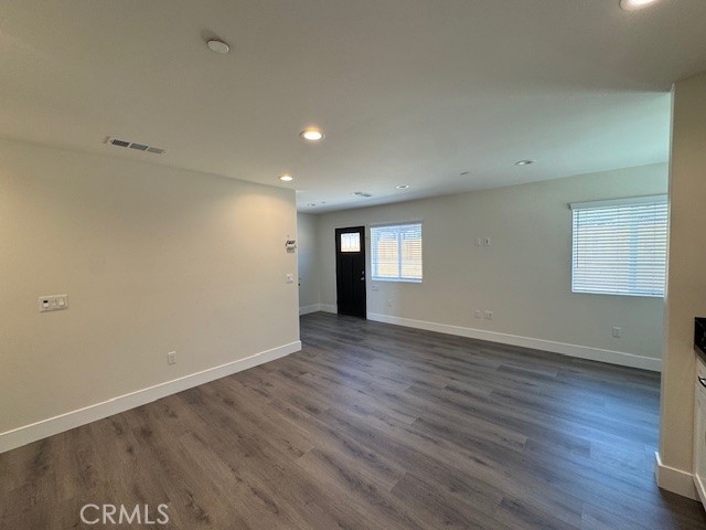 510 Ellis Lake, Unit 1 Lake Elsinore, CA 92530 - Photo 21 of 25 an empty room with wooden floor and windows