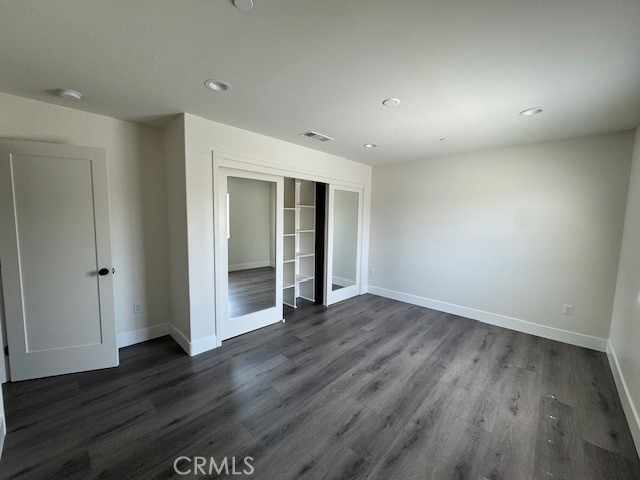 510 Ellis Lake, Unit 1 Lake Elsinore, CA 92530 - Photo 3 of 25 a view of an empty room with wooden floor
