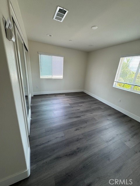 510 Ellis Lake, Unit 1 Lake Elsinore, CA 92530 - Photo 9 of 25 an empty room with wooden floor and windows