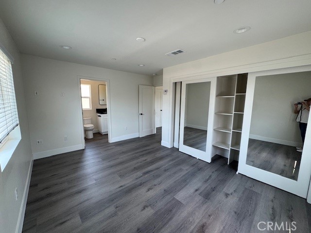 510 Ellis Lake, Unit 1 Lake Elsinore, CA 92530 - Photo 10 of 25 an empty room with wooden floor and windows