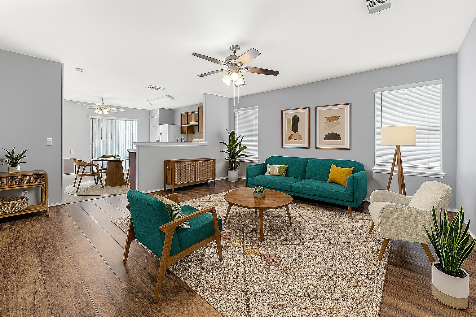 a living room with furniture and a wooden floor