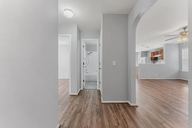 a kitchen with a refrigerator sink and cabinets