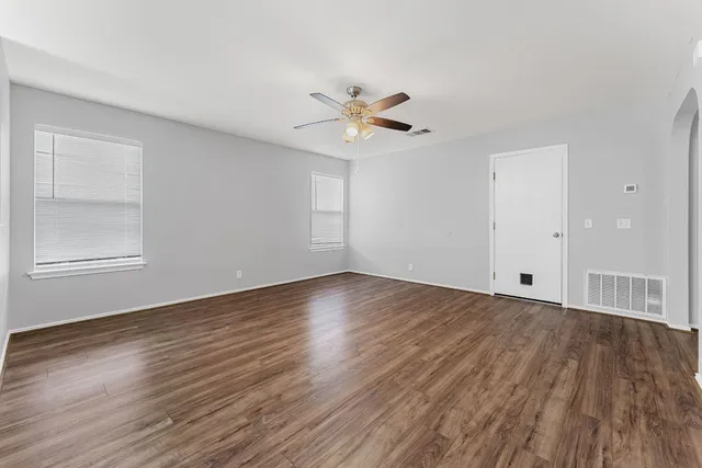 wooden floor in an empty room with a window
