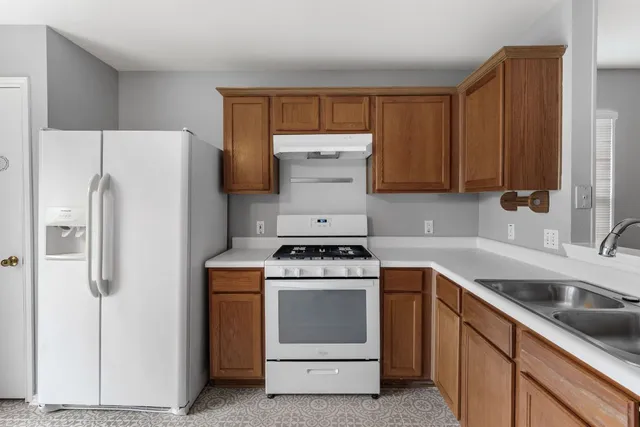 a kitchen with a stove sink and refrigerator