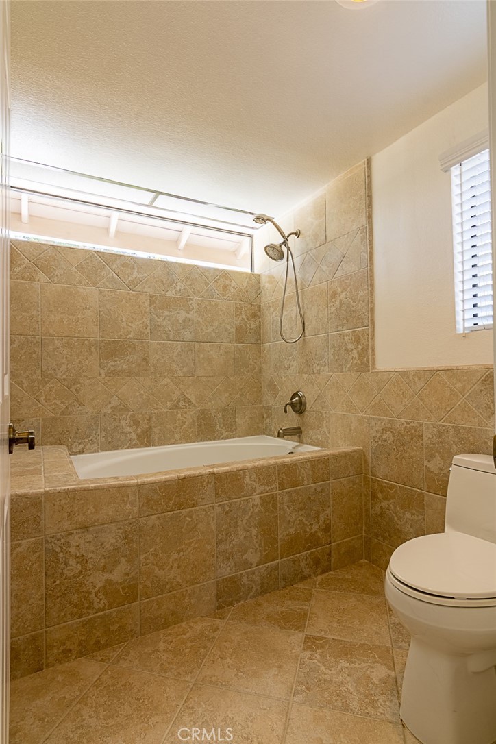 24 Brena Irvine, CA 92620 - Photo 18 of 28 a bathroom with a shower a toilet and a sink