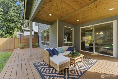 a balcony with furniture and wooden floor