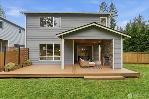 a view of a house with a yard and sitting area