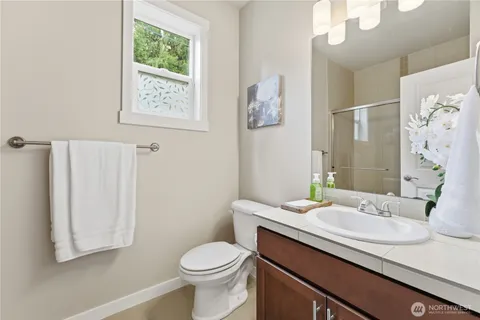 a bathroom with a granite countertop sink toilet and shower