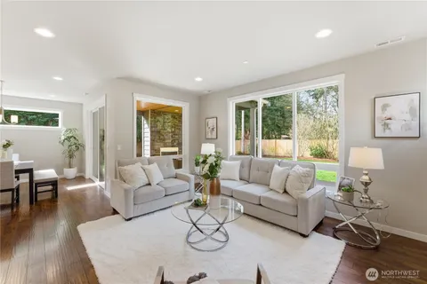 a living room with furniture and large windows