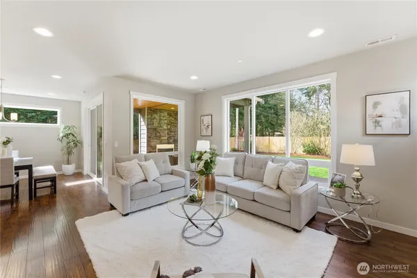 a living room with furniture and large windows