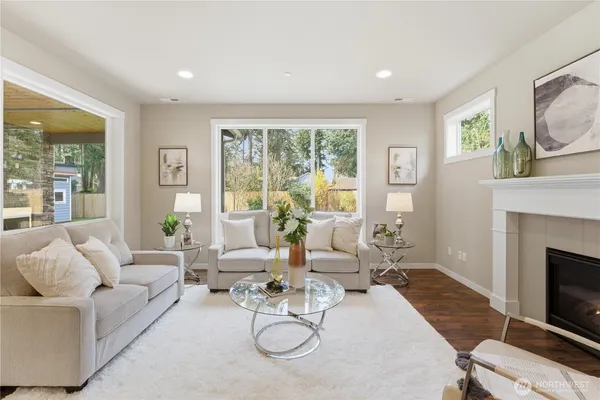 a living room with furniture a large window and a fireplace