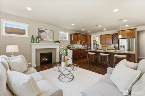 a living room with furniture and a kitchen