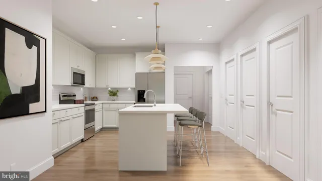 a living room with kitchen island furniture and a chandelier