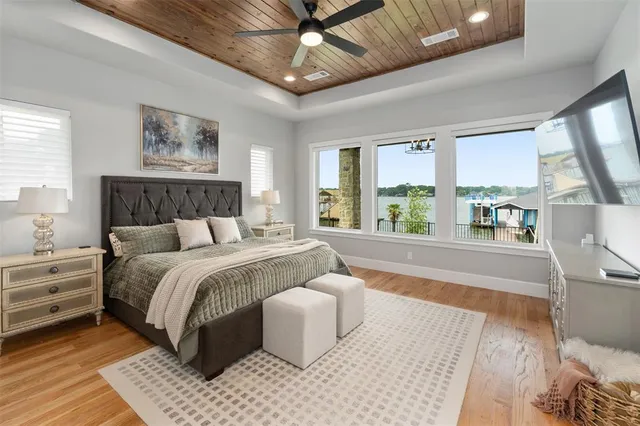 a spacious bedroom with a large bed and a large window