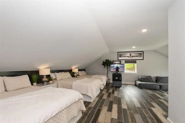 a bedroom with two beds and a couch