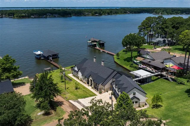 an aerial view of a house with a lake view