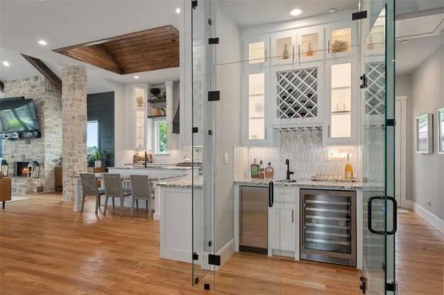 a kitchen with cabinets and wooden floor