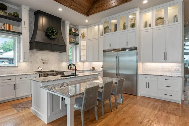 a kitchen with cabinets and stainless steel appliances