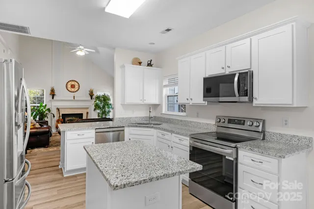 a kitchen with a stove microwave and sink