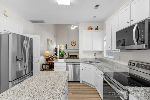 a kitchen with a sink stove and refrigerator