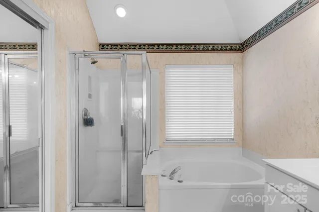 a bathroom with a bathtub and a shower