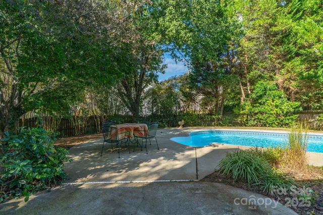 a view of a backyard with large trees