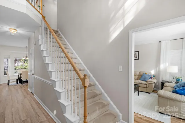 a view of entryway and hall with wooden floor