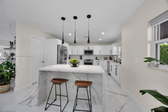 a kitchen with kitchen island cabinets and wooden floor