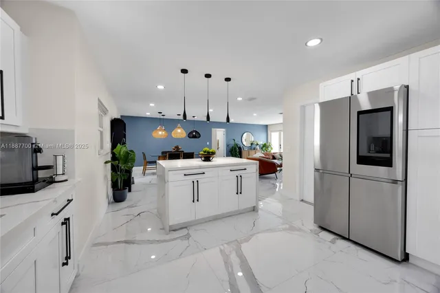 a kitchen with cabinets and stainless steel appliances