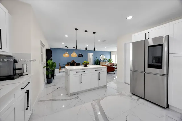 a kitchen with cabinets and stainless steel appliances