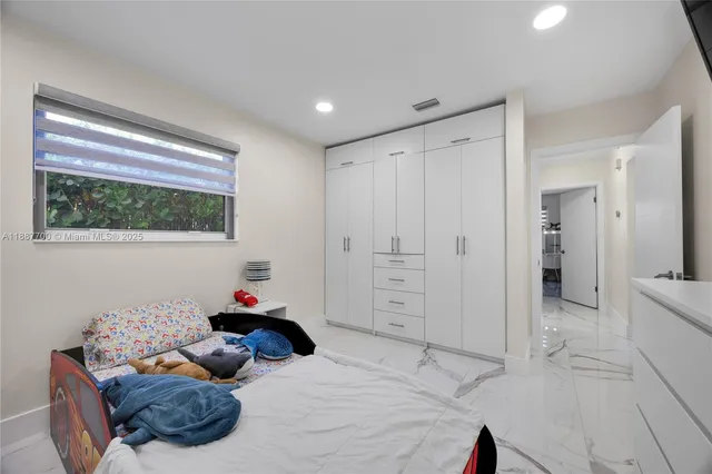 a bedroom with a bed and a window