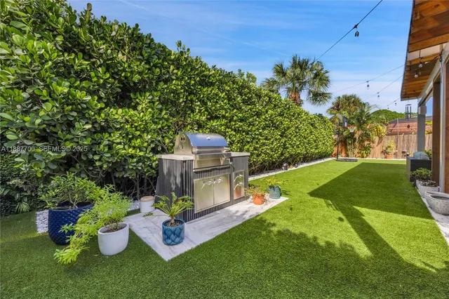 a view of a backyard with plants and a patio